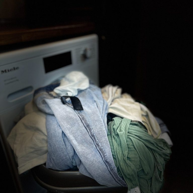 Wash basket next to a washing machine